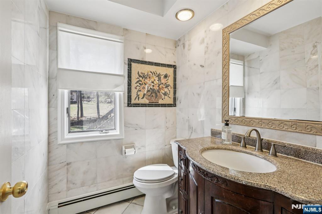 11 Carlough Road Upper Saddle River, NJ 07458 - Photo 25 of 41 a bathroom with a granite countertop sink toilet and mirror