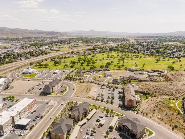 an aerial view of residential houses with outdoor space