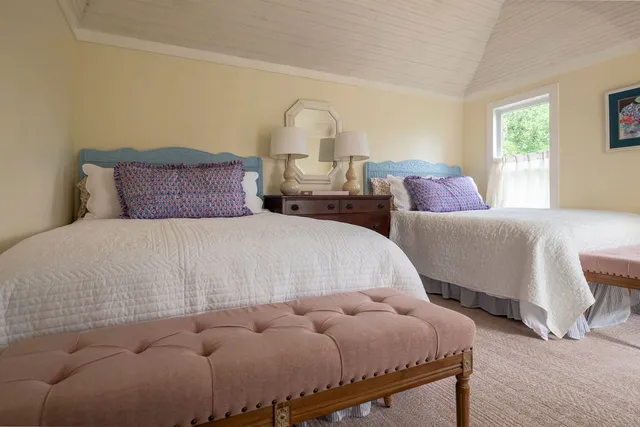 a bedroom with bed and window