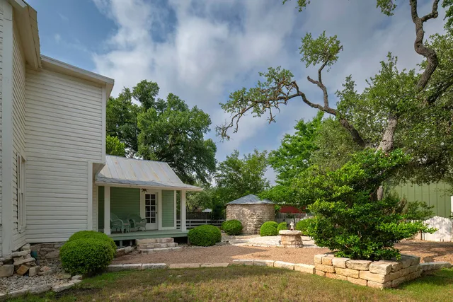 a house with lots of trees in the background