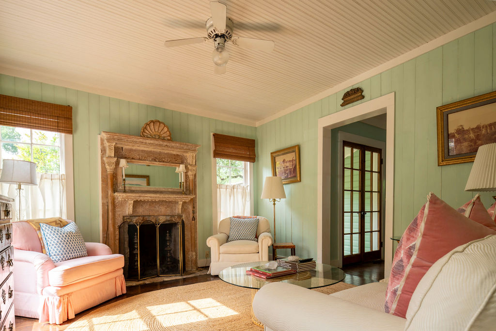 200 Bluff Street Dripping Springs, TX 78620 - Photo 4 of 16 a living room with furniture a fireplace and a large window