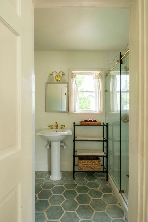 200 Bluff Street Dripping Springs, TX 78620 - Photo 7 of 16 a bathroom with a sink and a mirror