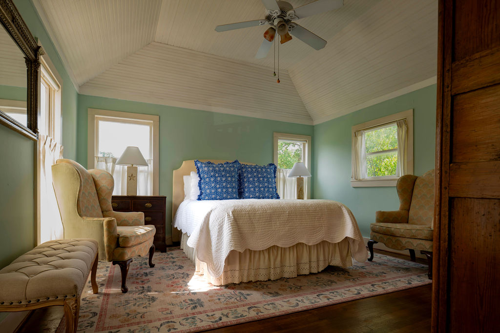 200 Bluff Street Dripping Springs, TX 78620 - Photo 8 of 16 a bedroom with a bed and wooden floor