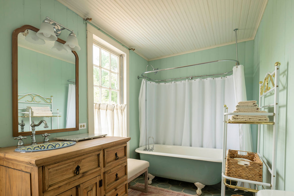 200 Bluff Street Dripping Springs, TX 78620 - Photo 9 of 16 a bathroom with a bathtub sink and mirror