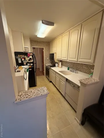 a kitchen with a stove a sink dishwasher and a refrigerator