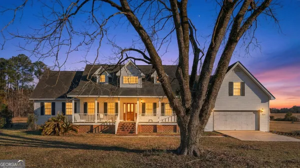 a view of kitchen with white wooden cabinets and wooden floor