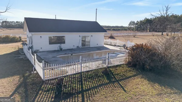 a view of a dining room with furniture a chandelier and wooden floor