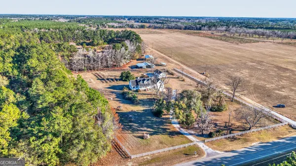 an empty room with wooden floor and ceiling fan