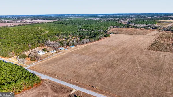 a view of a hallway with wooden floor and entryway