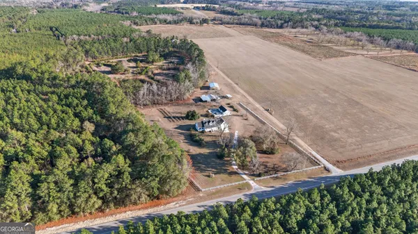 a view of an empty room with a chandelier fan