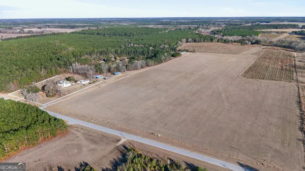 a large white kitchen with a large window appliances and cabinets