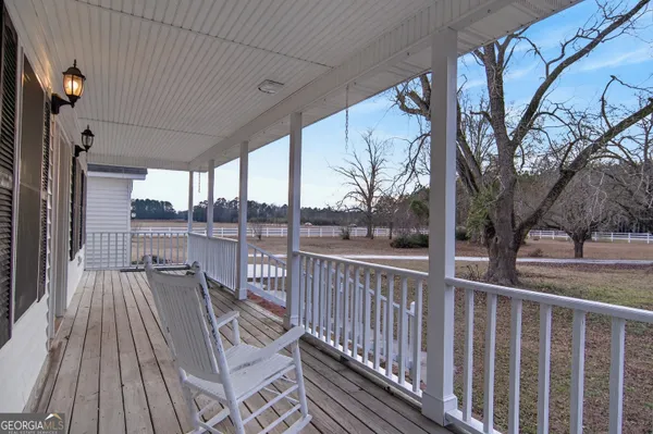a view of a house with pool and deck