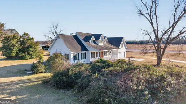 an aerial view of a house with a yard
