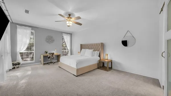 a bedroom with a bed and a chandelier