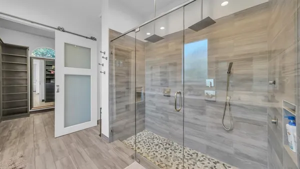 a bathroom with a glass shower door