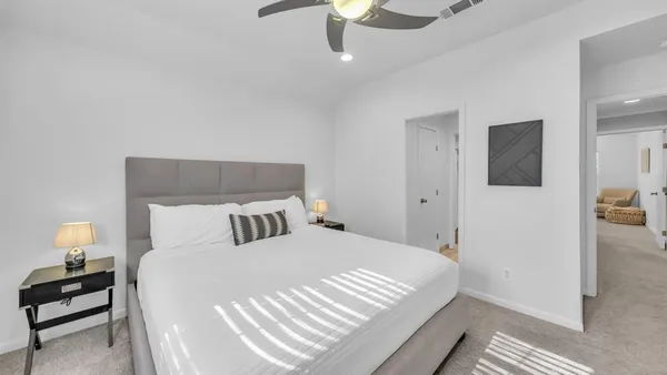 a bedroom with a bed and a lamp