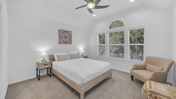 a bedroom with a bed and a couch