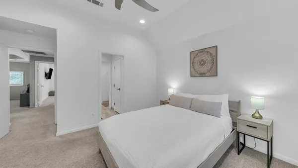 a bedroom with a bed and a lamp