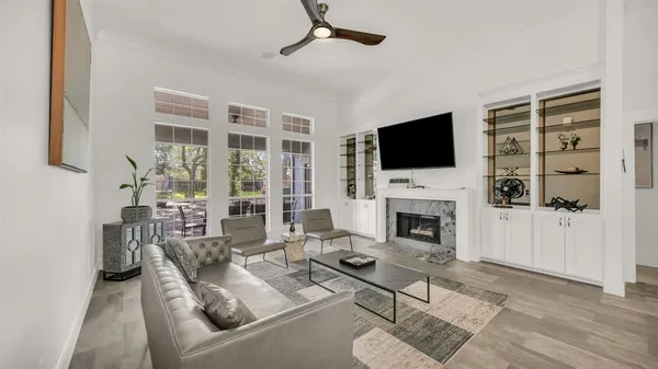 a living room with furniture a fireplace and a flat screen tv