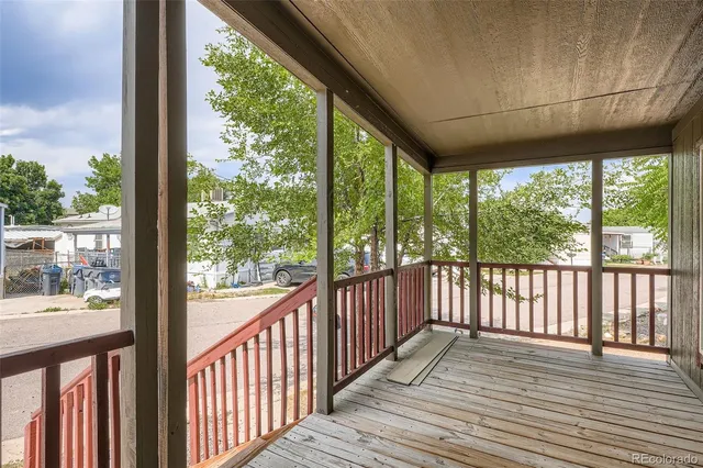 a view of a balcony with wooden floor