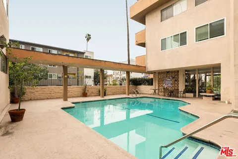 a view of a house with swimming pool and sitting area