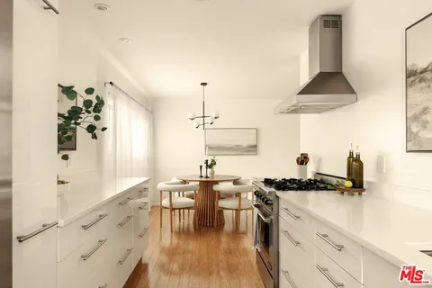 a kitchen with stainless steel appliances a stove a sink and a refrigerator