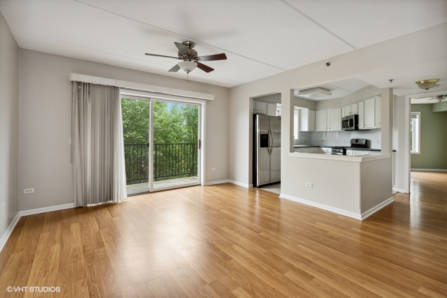 351 Town Pl Circle, Unit 405 Buffalo Grove, IL 60089 - Photo 5 of 13 a view of a kitchen with wooden floor and a ceiling fan