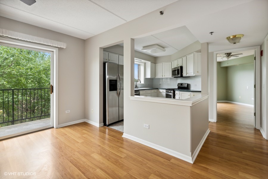 351 Town Pl Circle, Unit 405 Buffalo Grove, IL 60089 - Photo 7 of 13 a room with kitchen island a sink and a refrigerator
