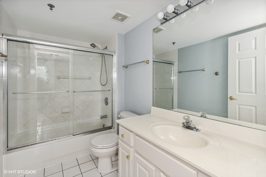 351 Town Pl Circle, Unit 405 Buffalo Grove, IL 60089 - Photo 9 of 13 a bathroom with a sink toilet and shower