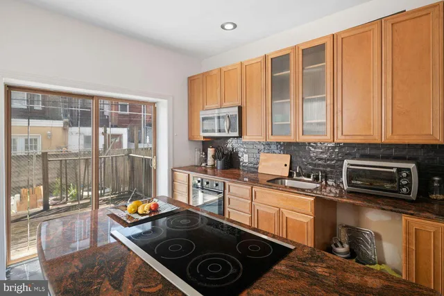 a kitchen that has a sink and a stove