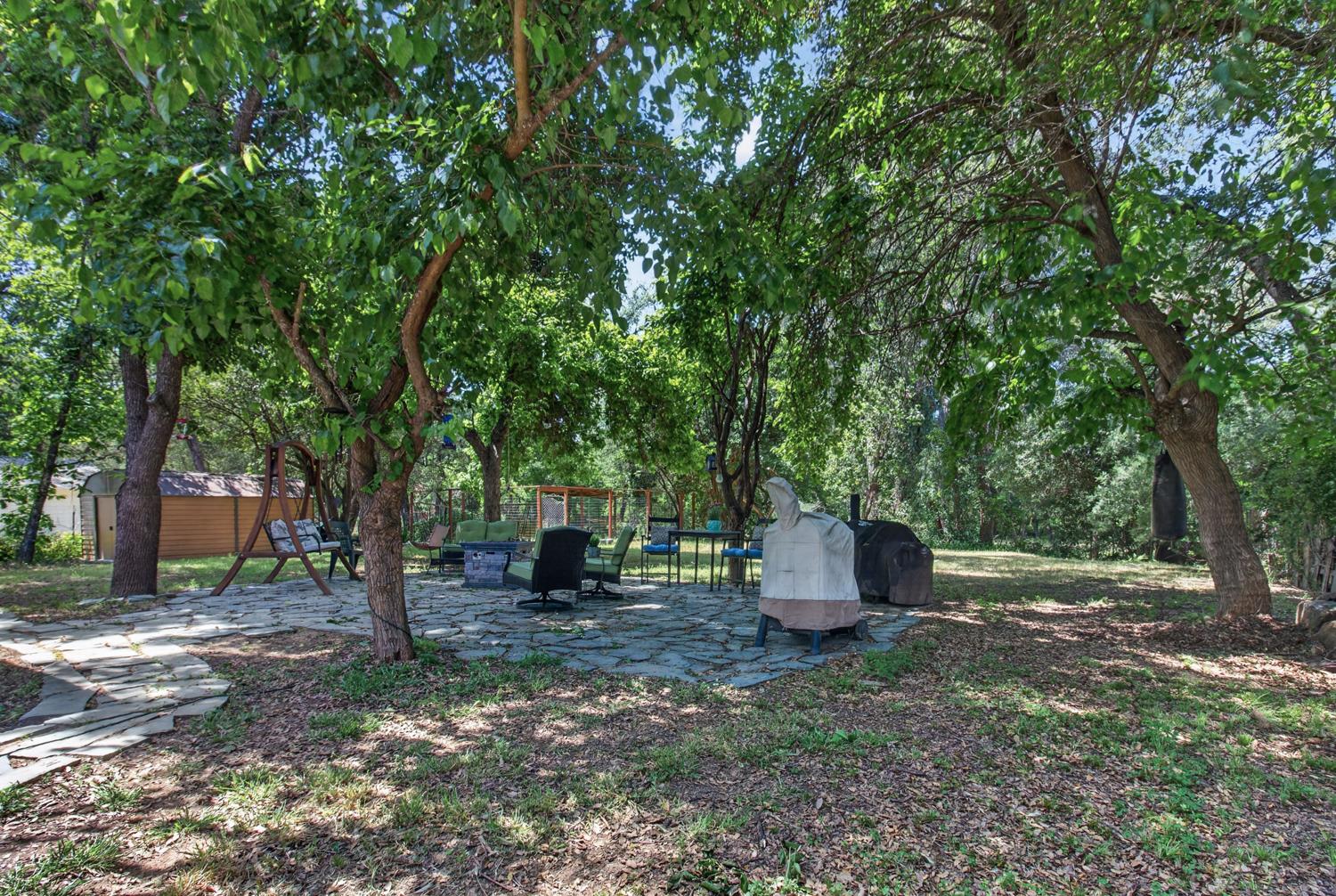 6332 Horseshoe Bar Road Loomis, CA 95650 - Photo 60 of 85 Expansive outdoor space featuring a flagstone patio, mature trees, and a separate storage shed