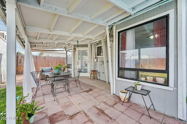 a view of a house with a yard and sitting area