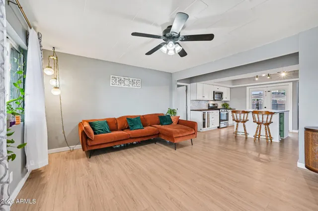 a living room with furniture and wooden floor