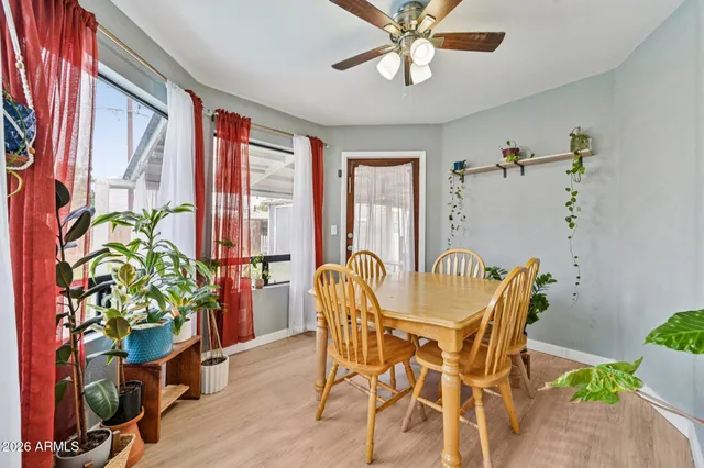 a dining room filled with furniture and a potted plant