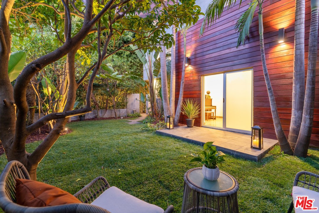 a backyard of a house with table and chairs