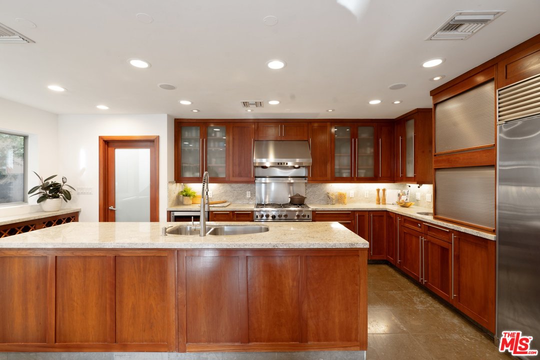 918 Howard Street Marina del Rey, CA 90292 - Photo 13 of 38 a kitchen with stainless steel appliances granite countertop wooden cabinets a sink and dishwasher