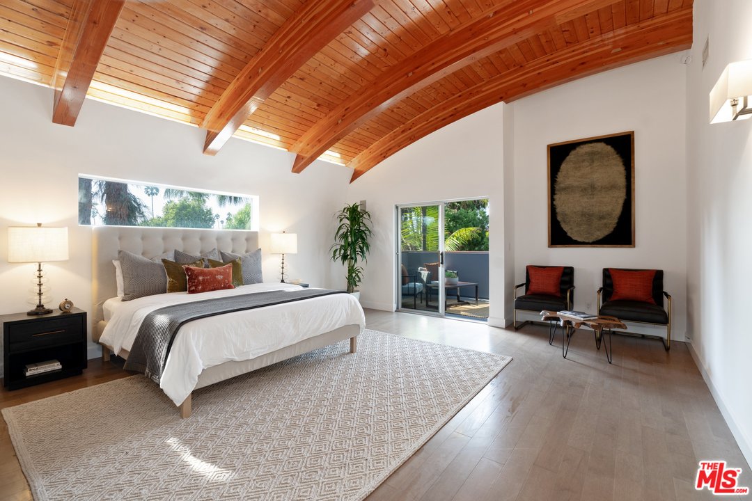 918 Howard Street Marina del Rey, CA 90292 - Photo 15 of 38 a spacious bedroom with a bed a couch and a chandelier