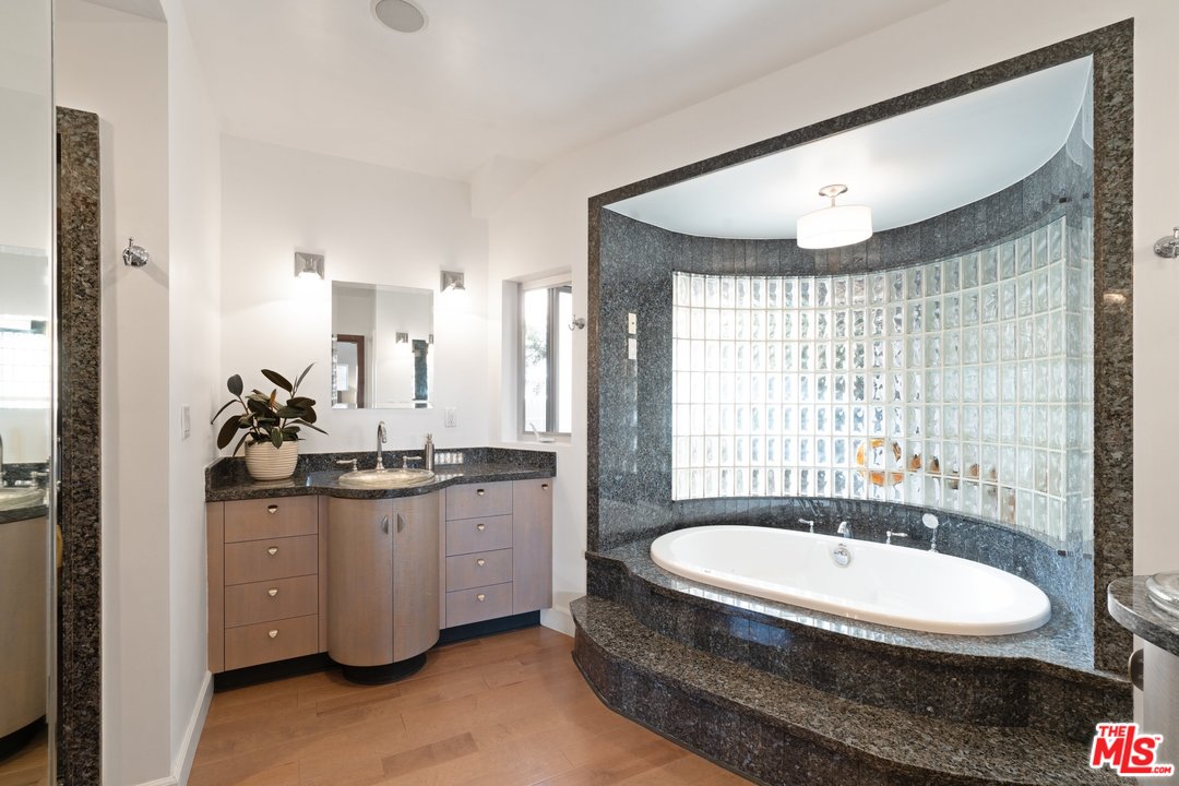 918 Howard Street Marina del Rey, CA 90292 - Photo 17 of 38 a bathroom with a granite countertop sink a toilet a mirror and shower