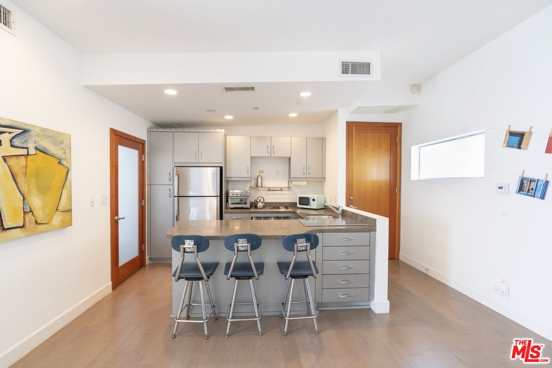 918 Howard Street Marina del Rey, CA 90292 - Photo 32 of 38 a view of a kitchen with a dining table and chairs