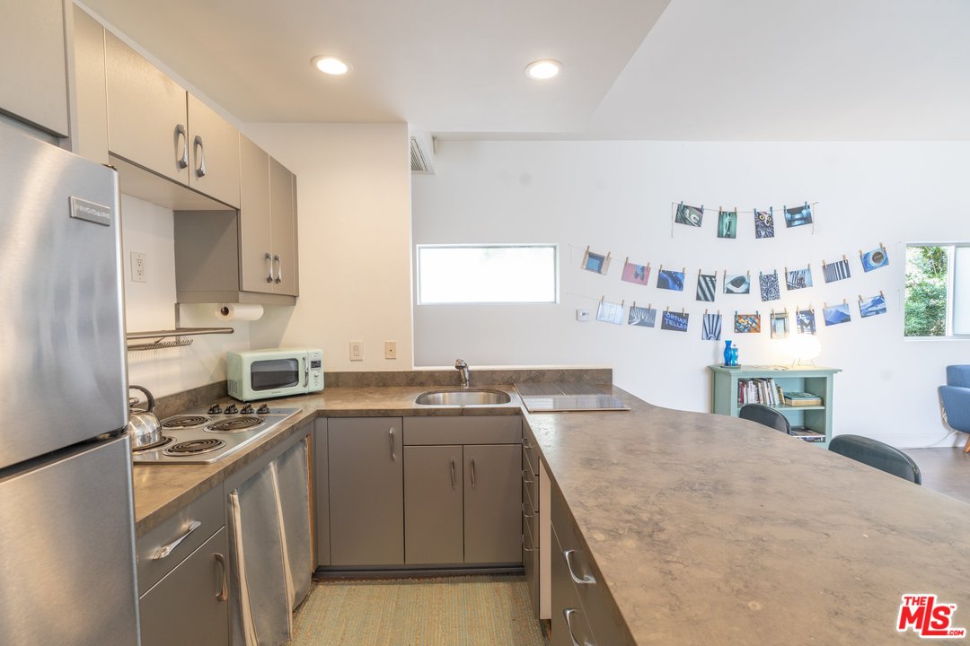 918 Howard Street Marina del Rey, CA 90292 - Photo 33 of 38 a kitchen with stainless steel appliances granite countertop a sink stove and cabinets