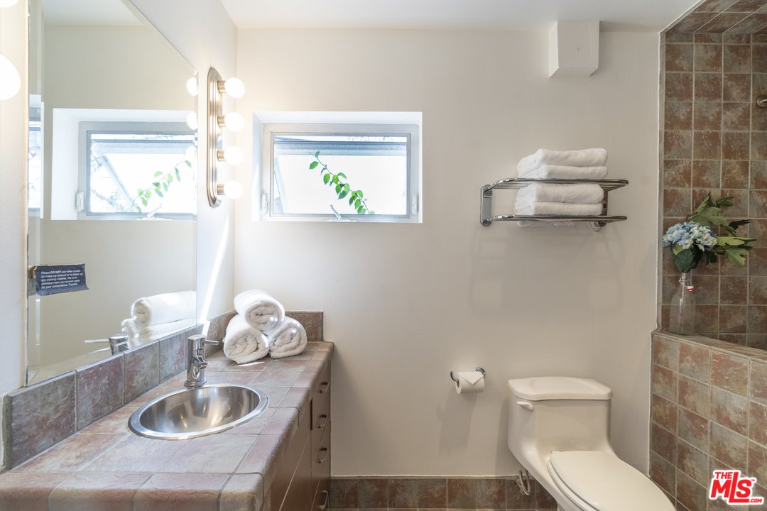 918 Howard Street Marina del Rey, CA 90292 - Photo 34 of 38 a bathroom with a toilet a sink and mirror