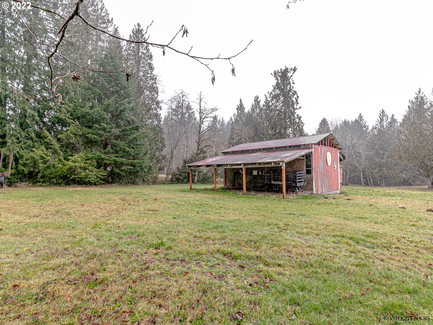40050 Southeast Paul Moore Road Sandy, OR 97055 - Photo 27 of 32 a backyard of a house with table and chairs