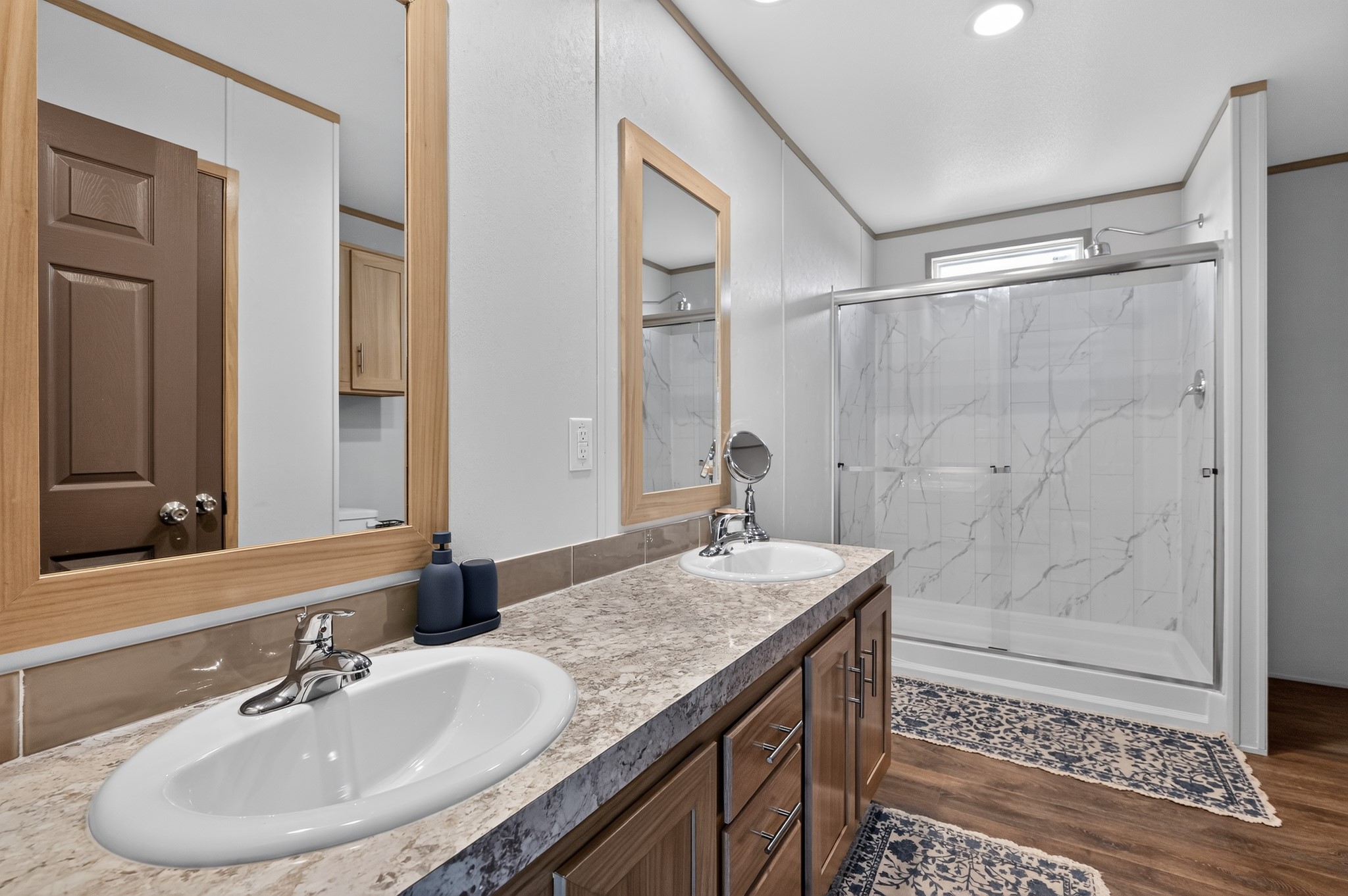 1134 Switchgrass Road Salado, TX 76571 - Photo 20 of 28 Double vanity and a spacious shower create a serene and practical bathroom environment.