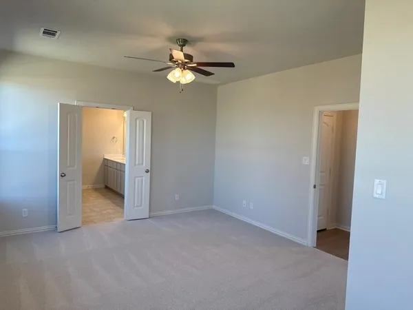 a view of an empty room with a bathroom