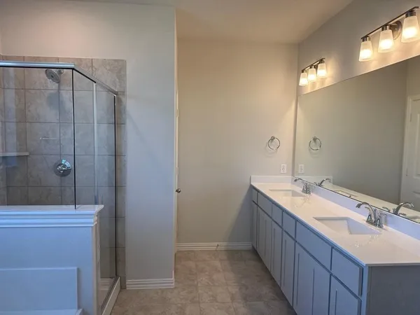 a bathroom with a double vanity sink a toilet and a mirror