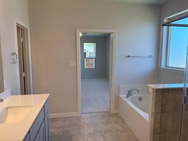 a bathroom with a bathtub and a sink