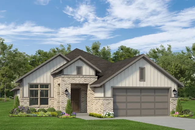 a front view of a house with a garden and yard