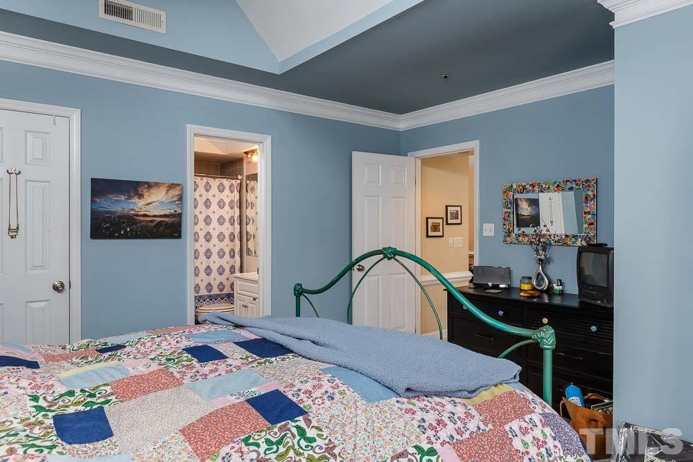 241 New Bern Place, Unit 301 Raleigh, NC 27601 - Photo 11 of 25 a bedroom with a bed and a dresser