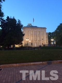 241 New Bern Place, Unit 301 Raleigh, NC 27601 - Photo 21 of 25 a large building with a yard in front