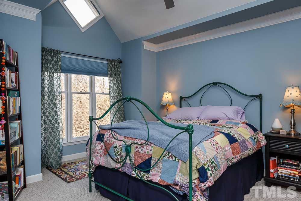 241 New Bern Place, Unit 301 Raleigh, NC 27601 - Photo 10 of 25 a bedroom with a bed with window